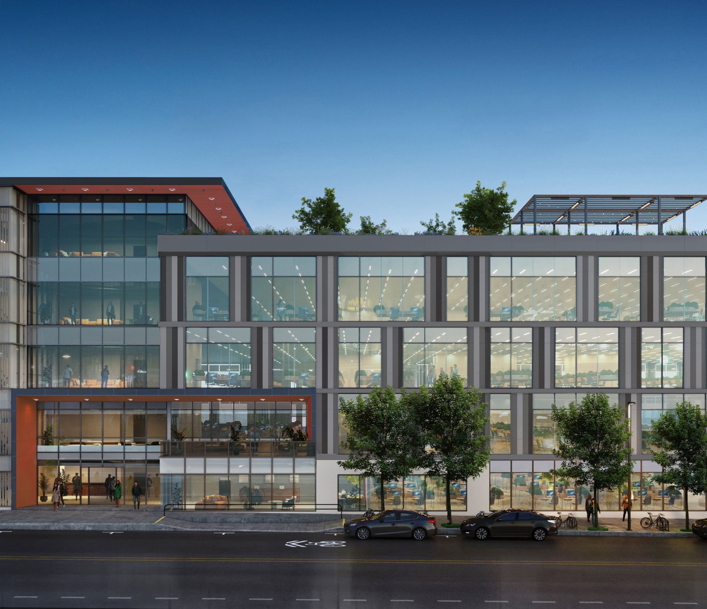 Modern glass-fronted office building at dusk