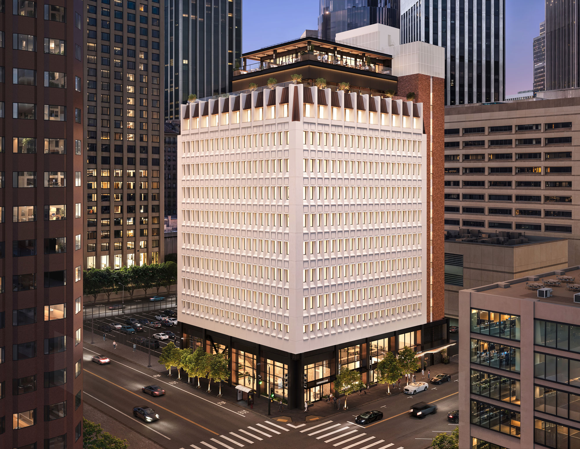 Modern office building with an illuminated façade and rooftop terrace
