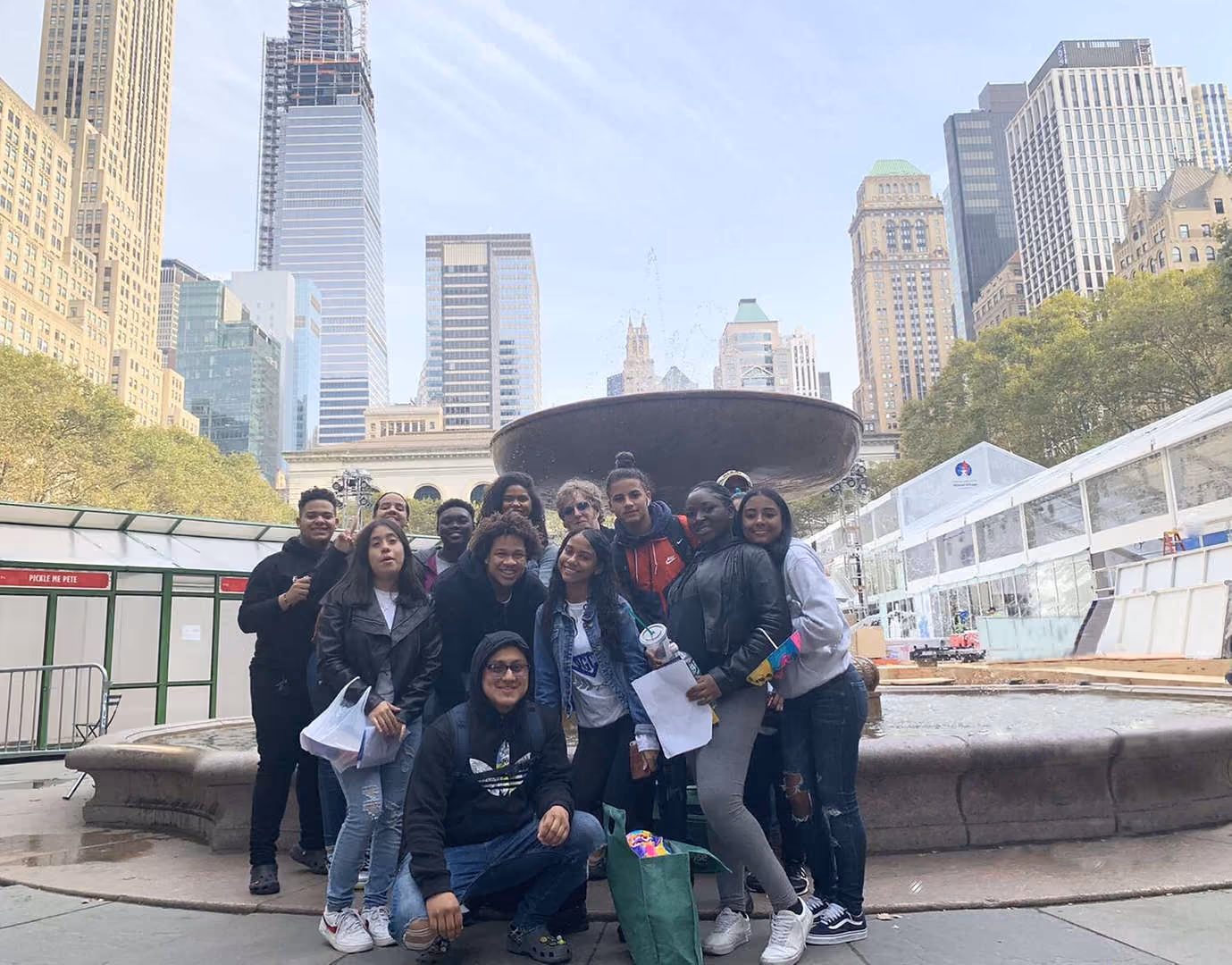 Students posing together at Bryant Park fountain in New York City