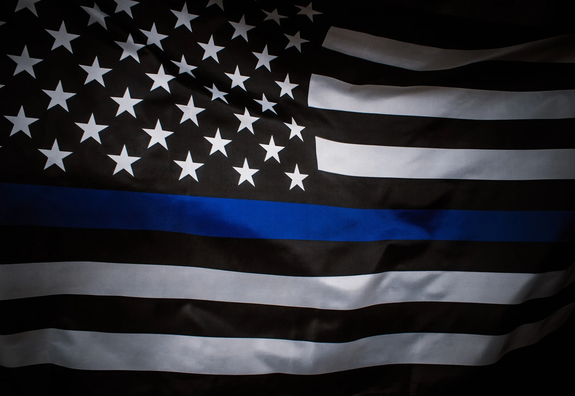 American flag in black and white with a single horizontal blue stripe across the center.