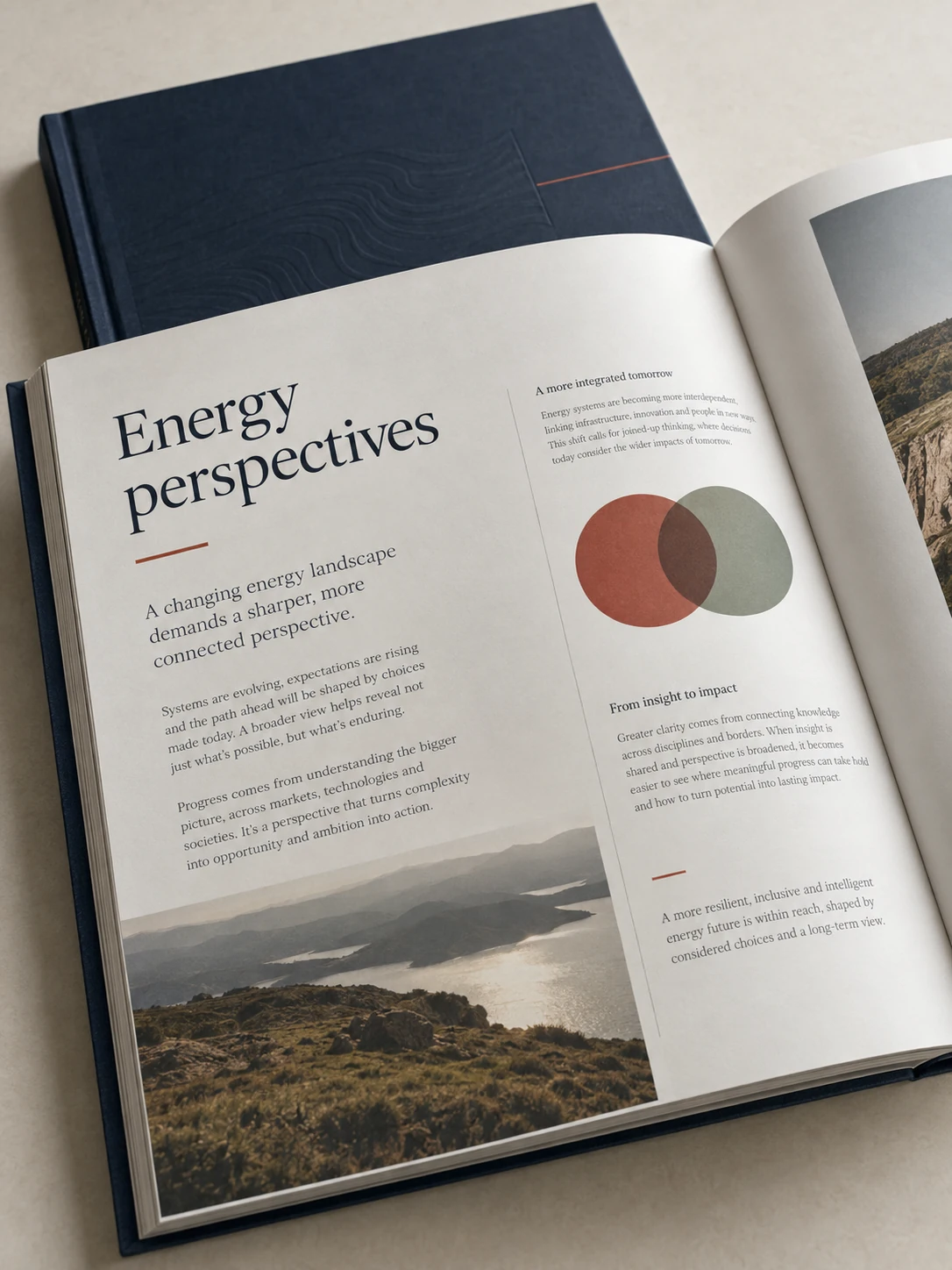 Open printed report with navy binding and a carefully structured editorial spread