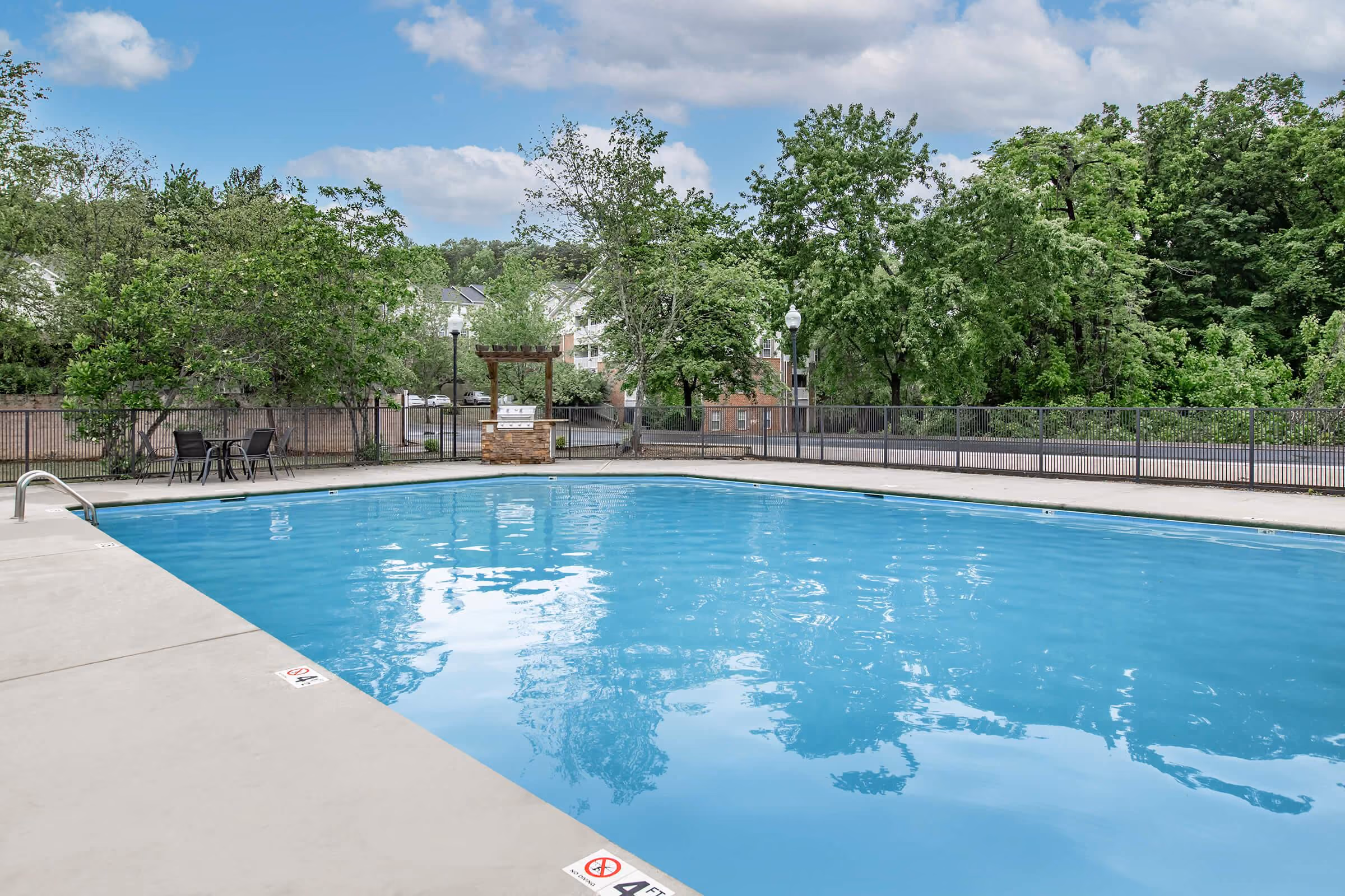 Pool with grill on patio area