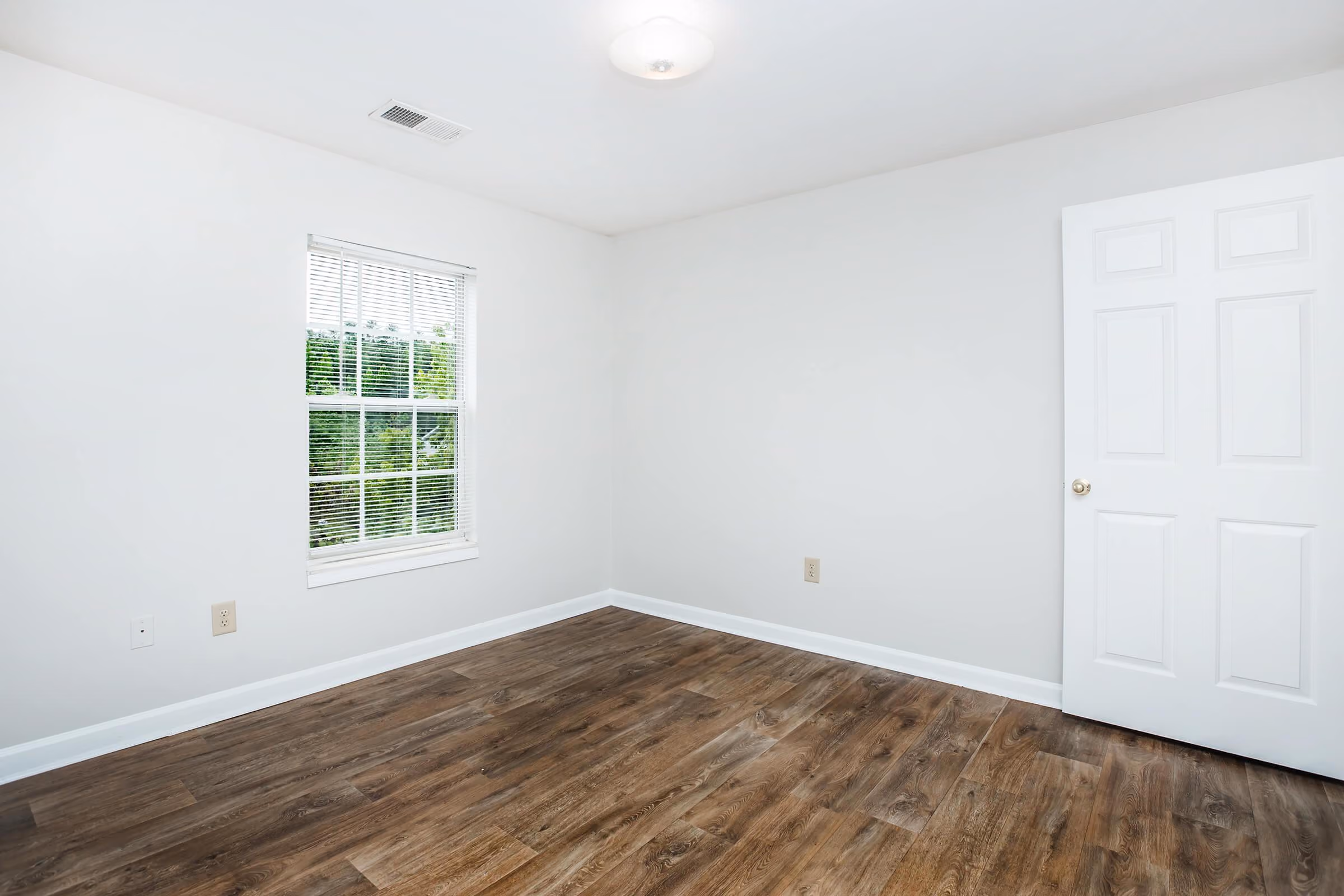 Bedroom with brown flooring 