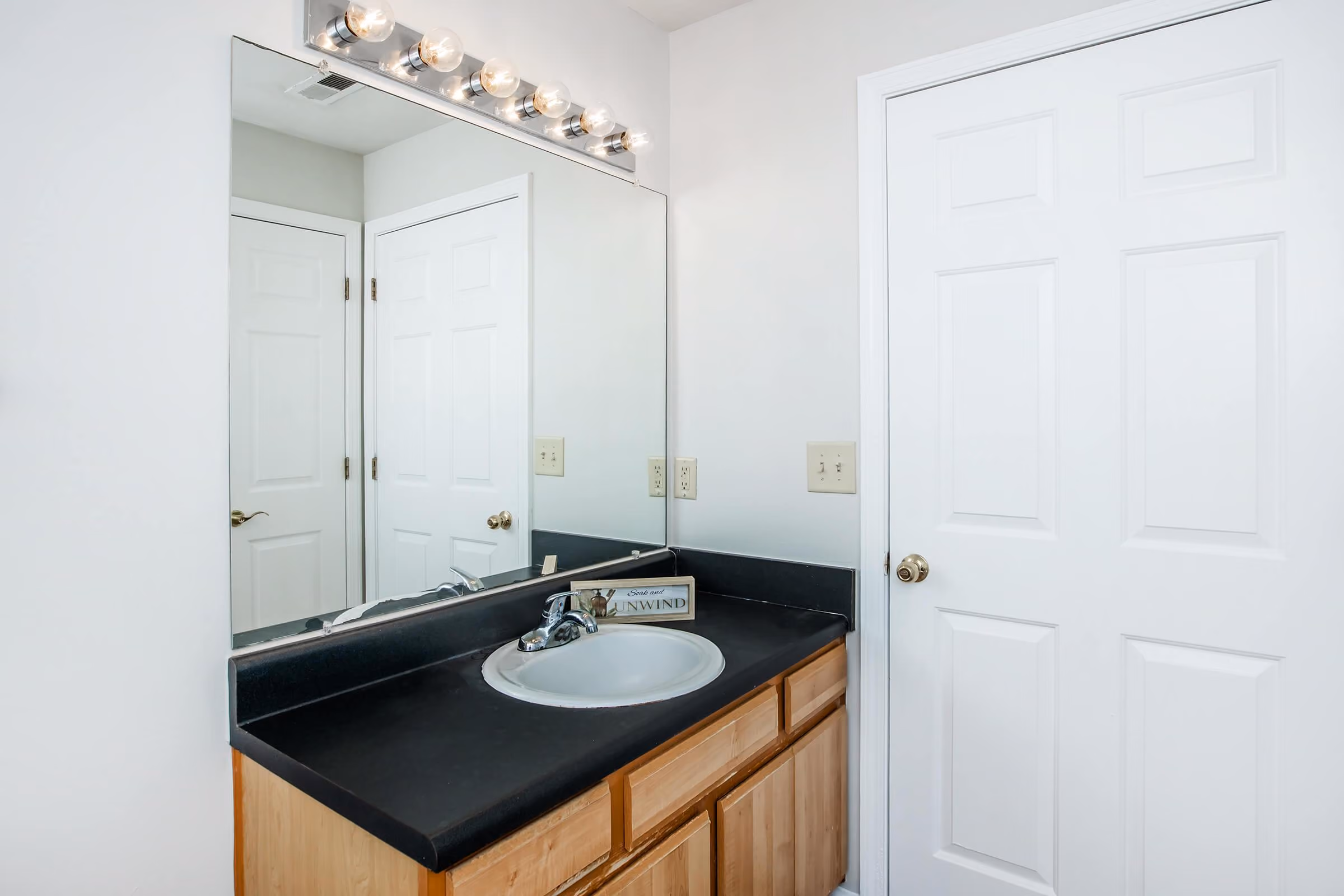Bathroom vanity with black counter tops