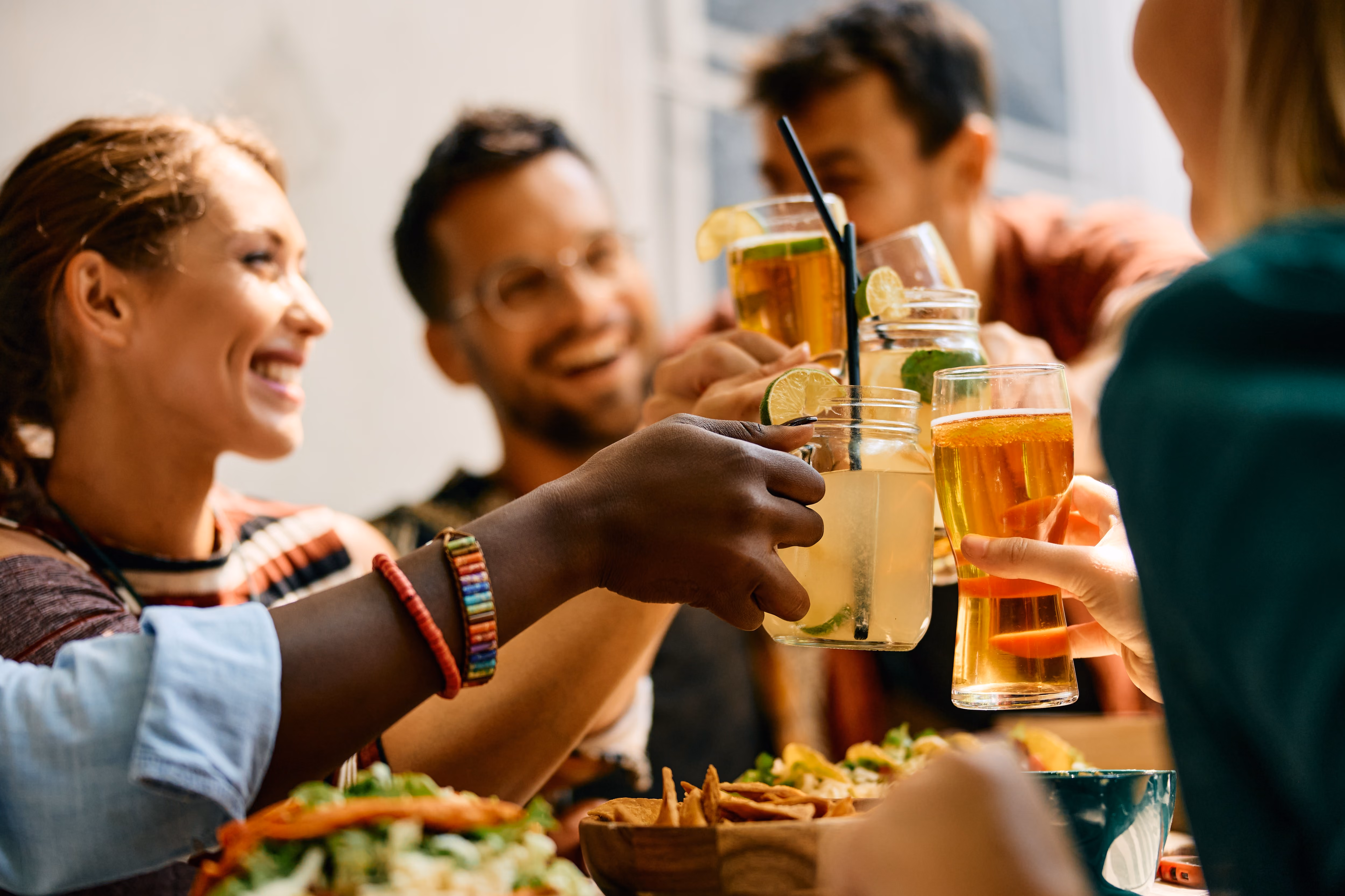 People doing a cheers with beverages stock iamge