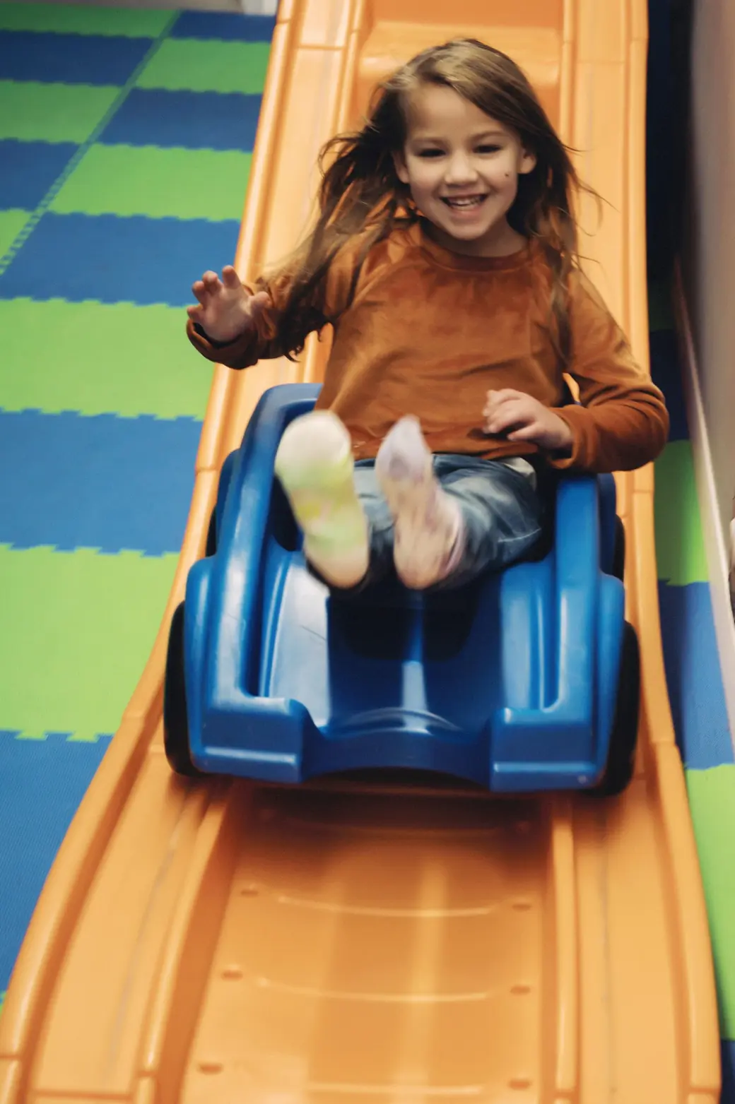 A child coming down the indoor slide at Black Bear Academy