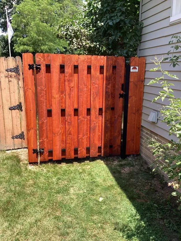 newly stained fence on side of home