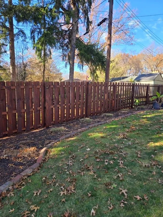 stained wood fence with garden plot