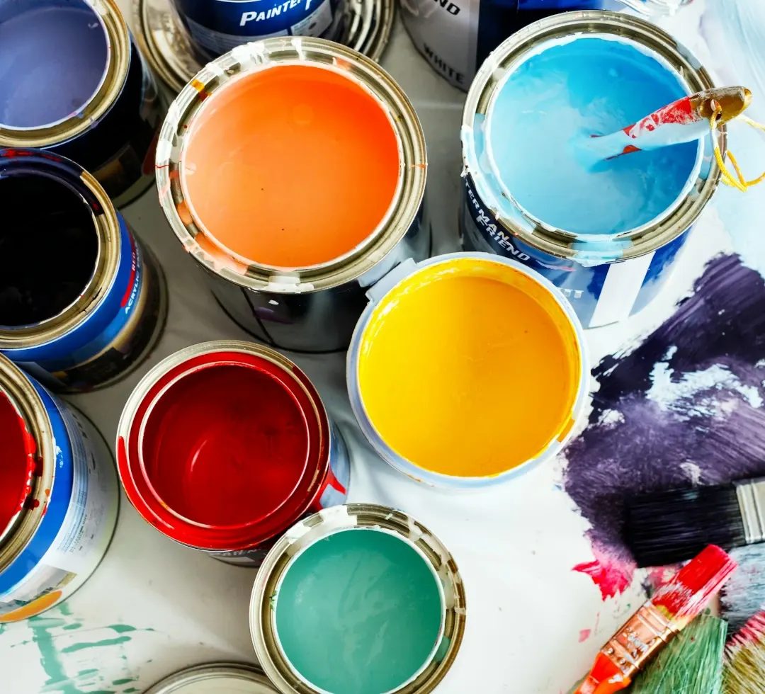 open paint cans next to each other