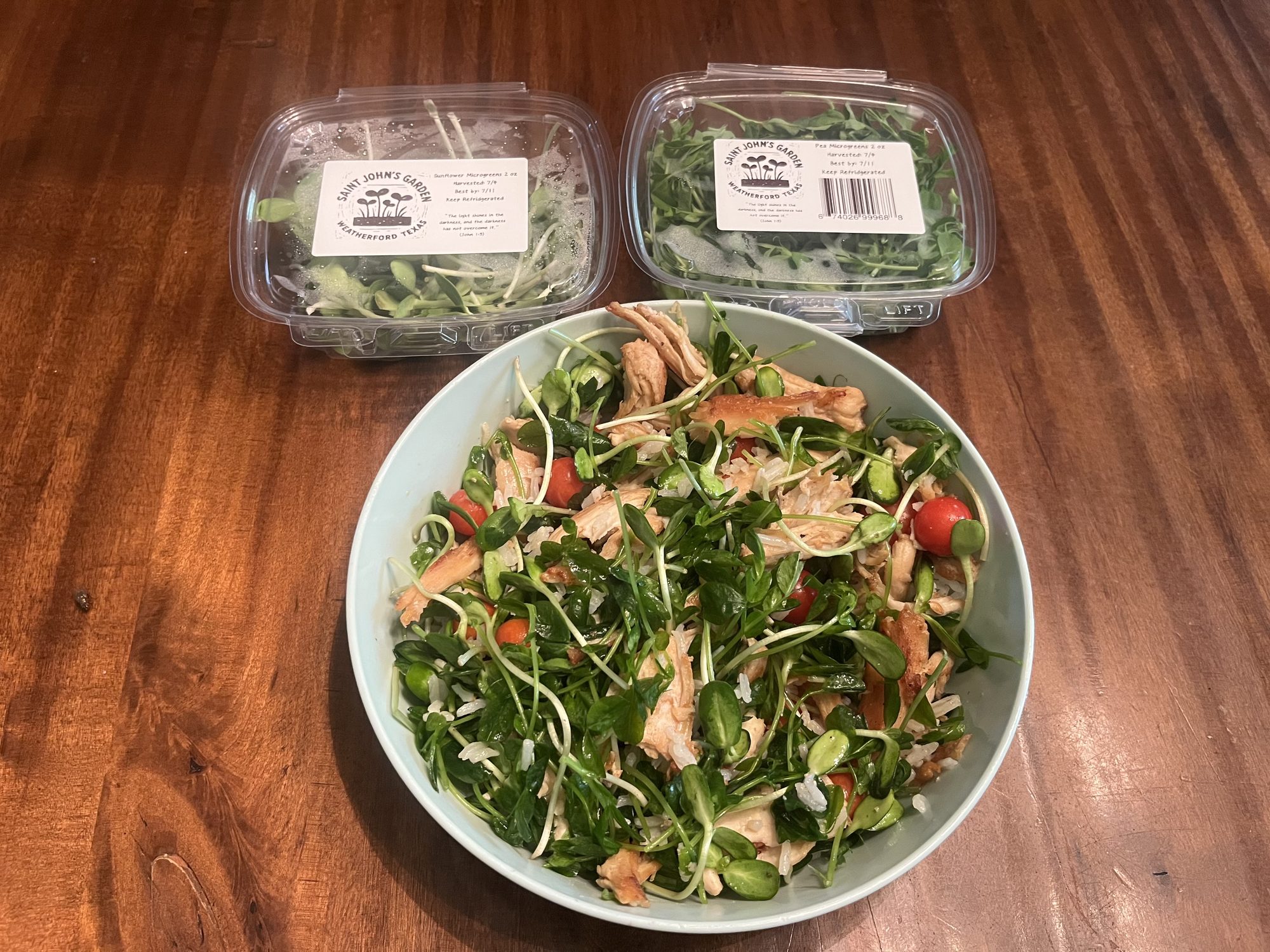A salad bowl topped with fresh Saint John's Garden microgreens