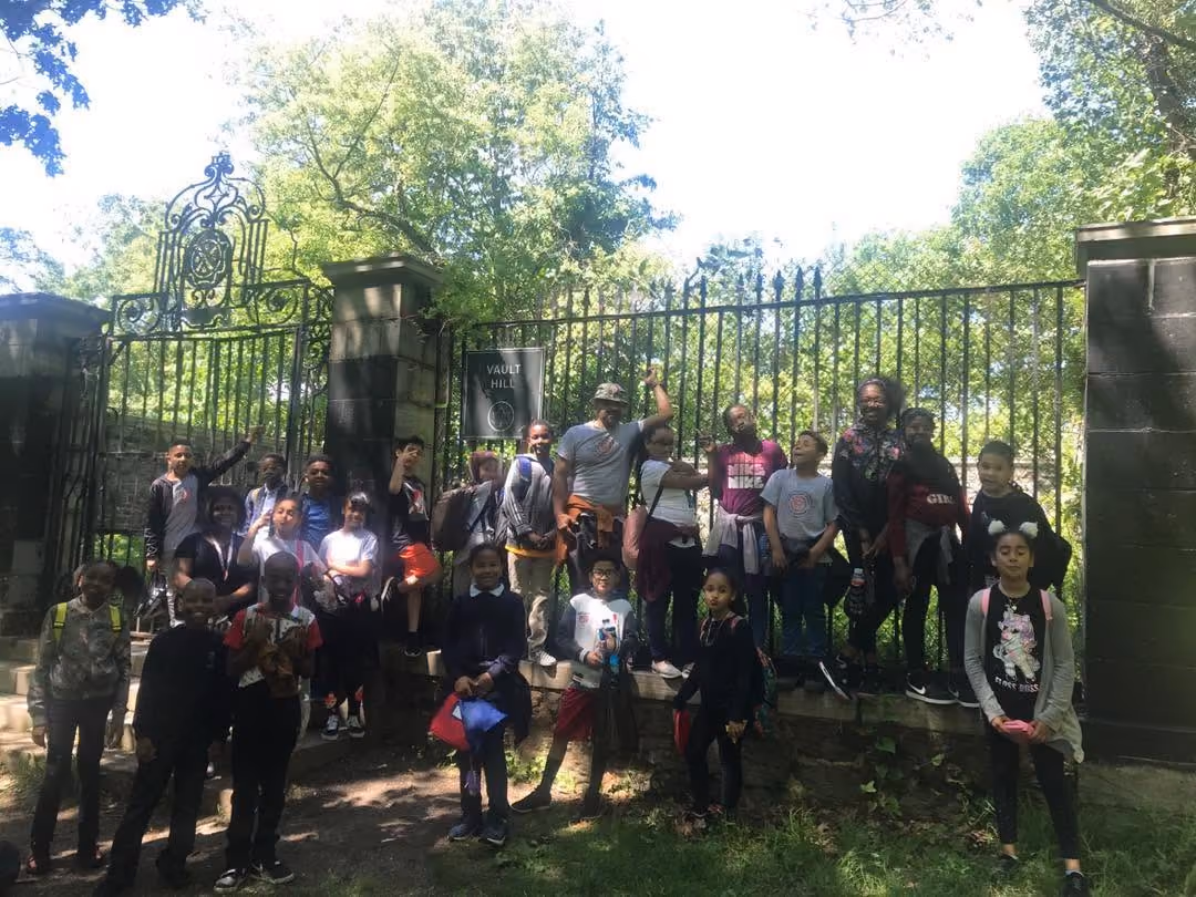 Students and teachers posing at Vault Hill gate on a field trip