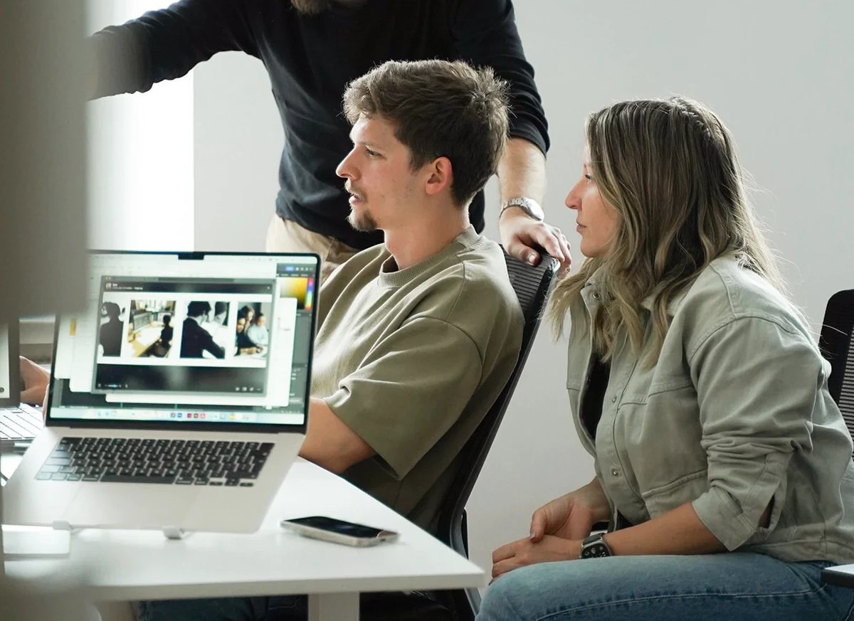 Business leaders discussing work at a laptop