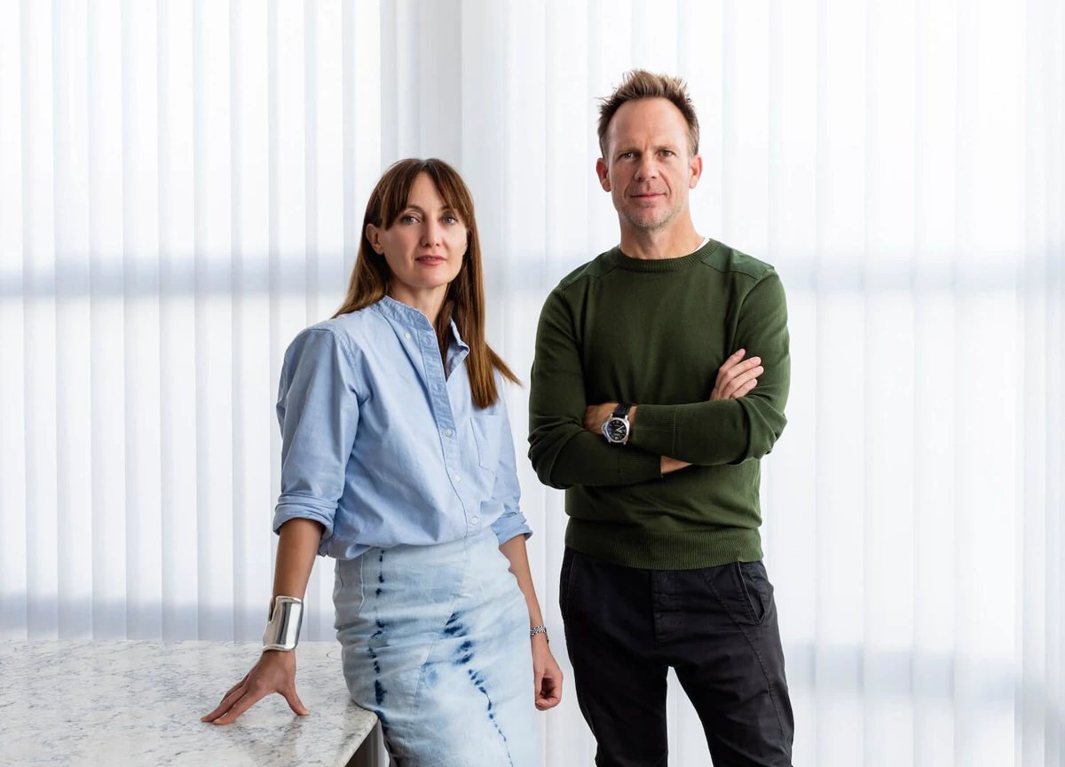 Two business professionals standing in a bright office