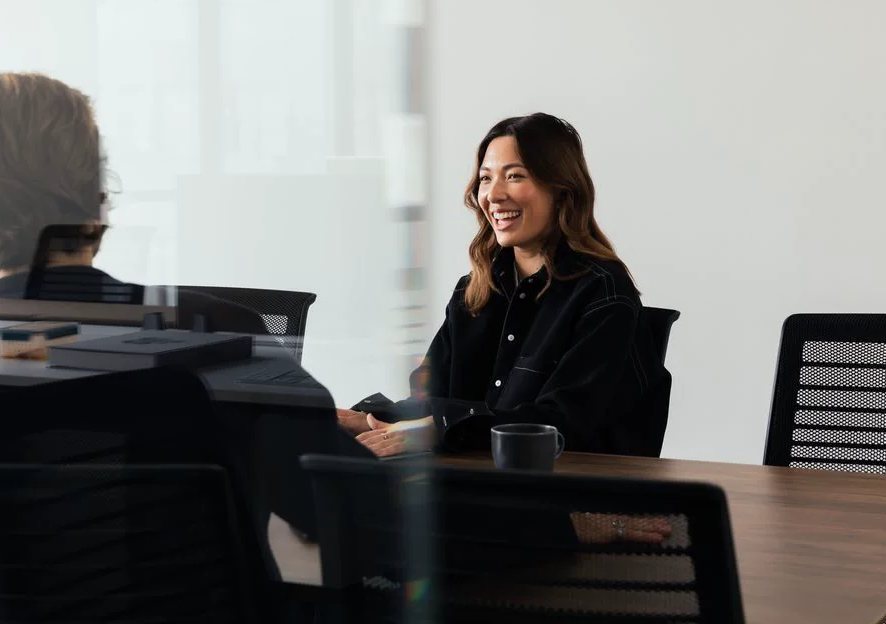 Smiling businesswoman at a meeting table