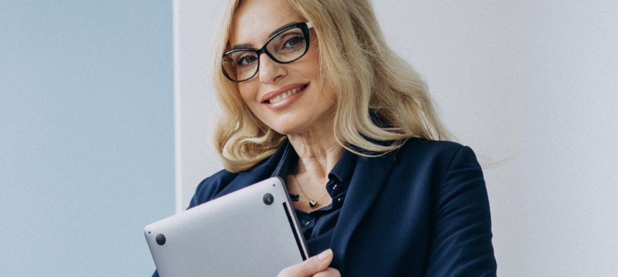Smiling businesswoman holding a laptop