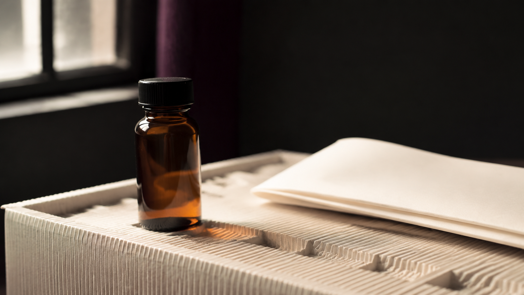 An unlabelled amber sample bottle on a shipping tray beside its documentation