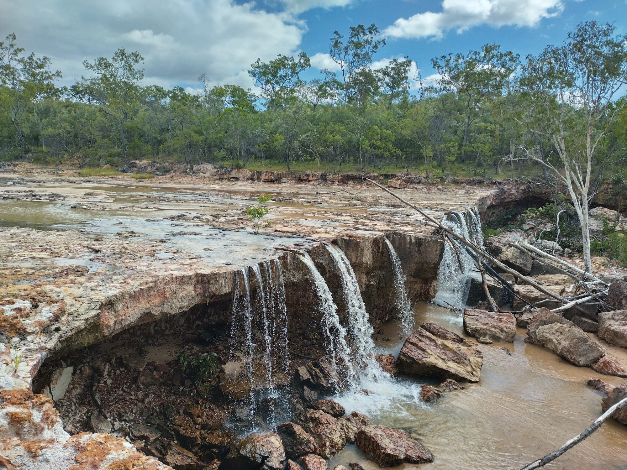 Water running over a wide rock shelf after the wet