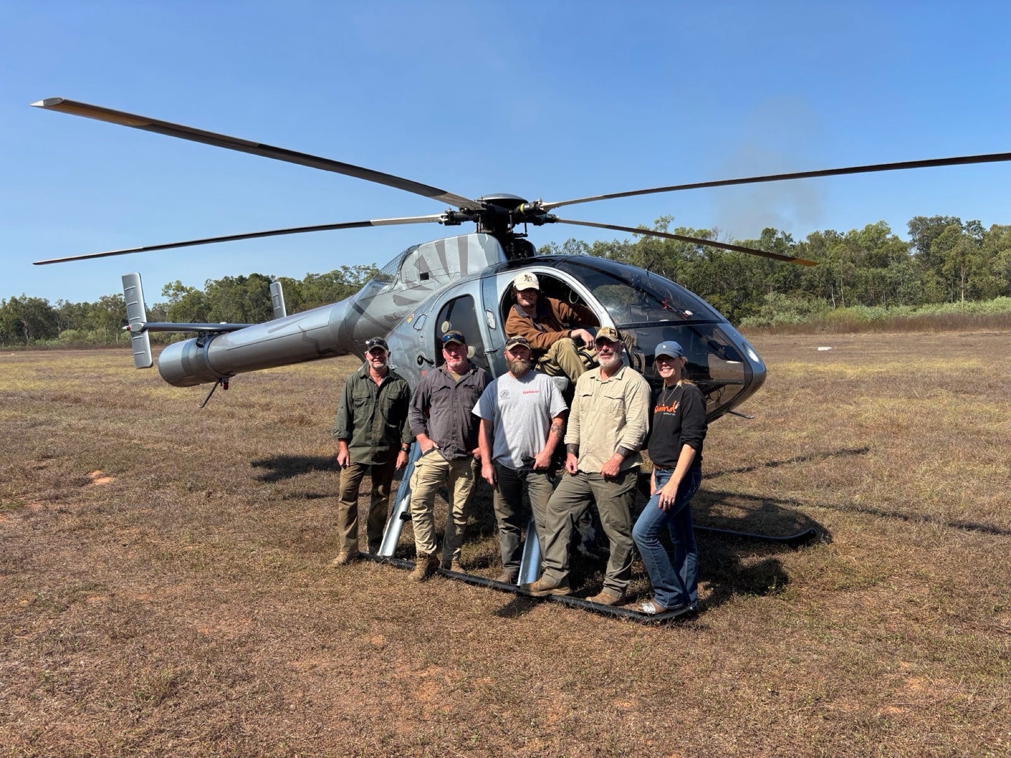 A group gathered at the helicopter before heading out
