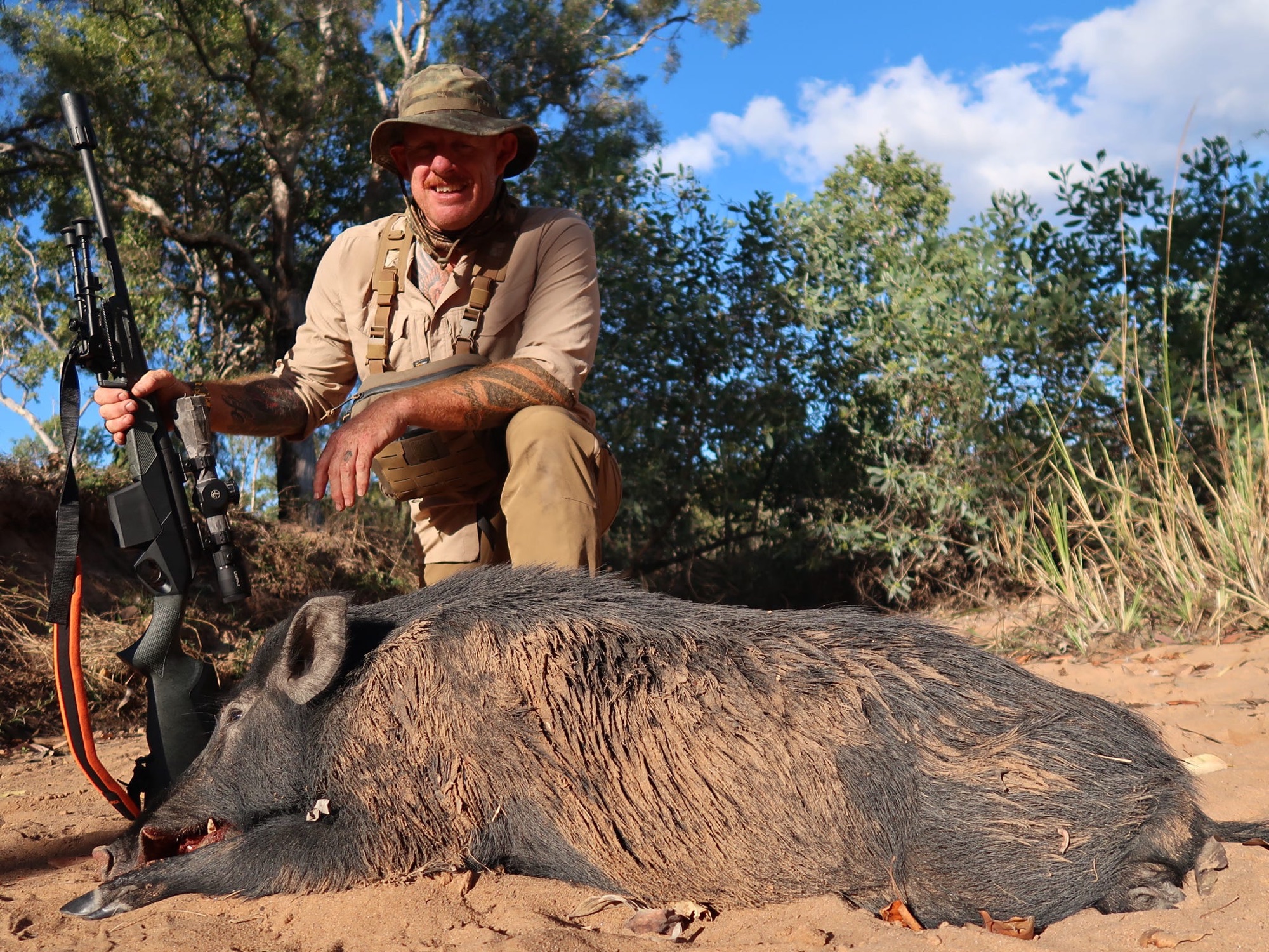A hunter and a wild boar in warm evening light