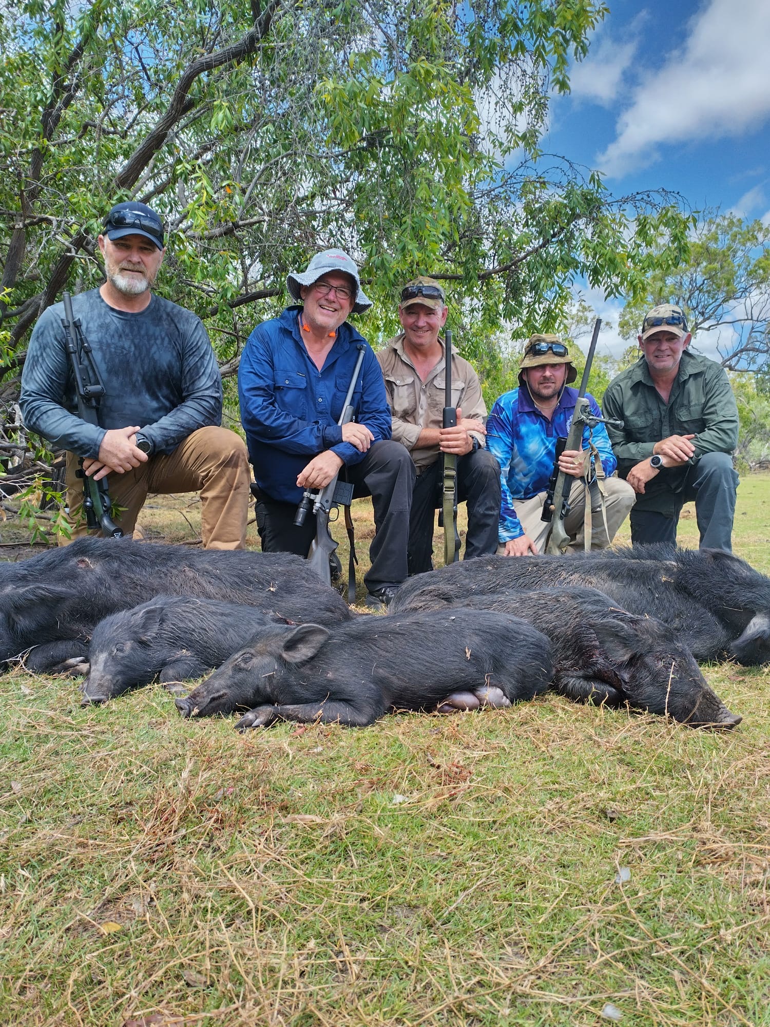 A group of hunters with wild boar taken over a morning