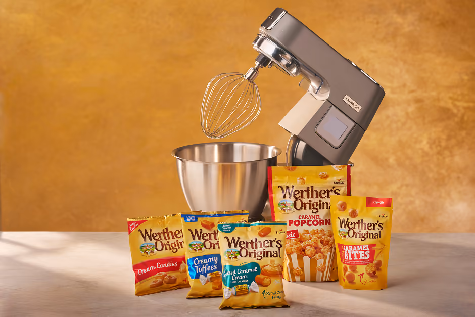 Kenwood stand mixer with metal bowl and an assortment of Werther’s Original candy packages.