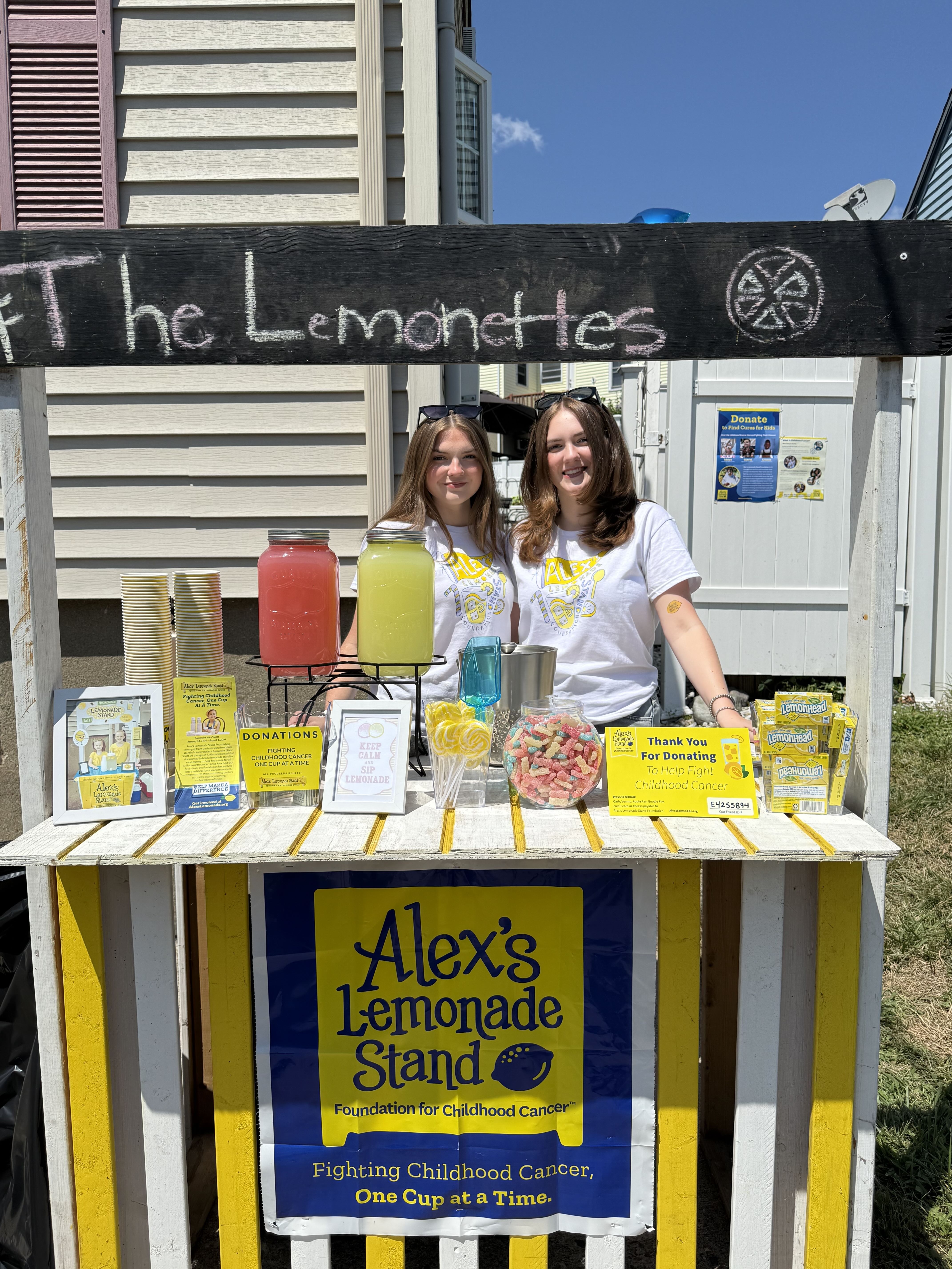 Kayla and Jordan Martelli behind their Alex's Lemonade Stand on Dale Street in Revere