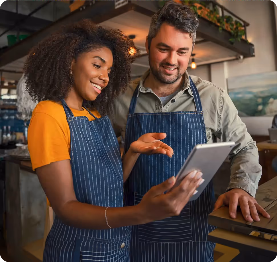 Two small business owners reviewing funding options on a tablet