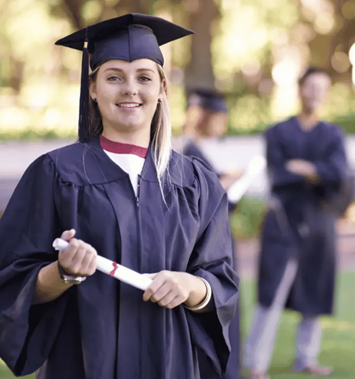 university girl smiling and holding her degree roll in hands