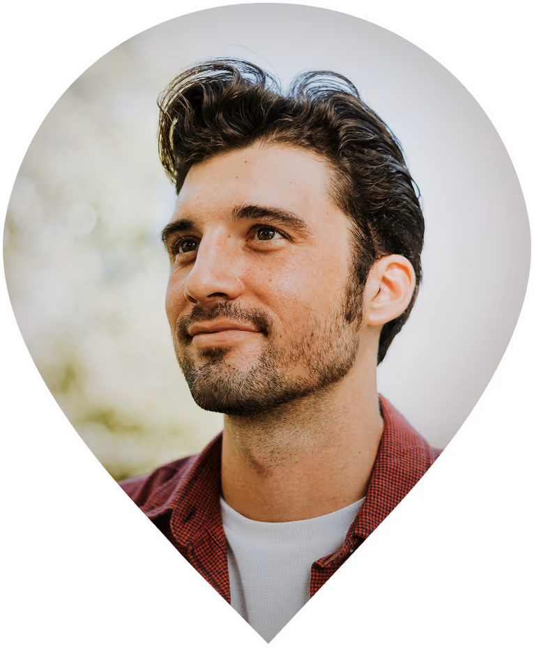 Young man with tousled hair looking thoughtfully into the distance