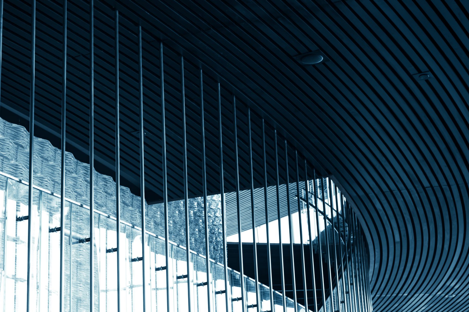 Contemporary architectural interior with glass facade and curved ceiling