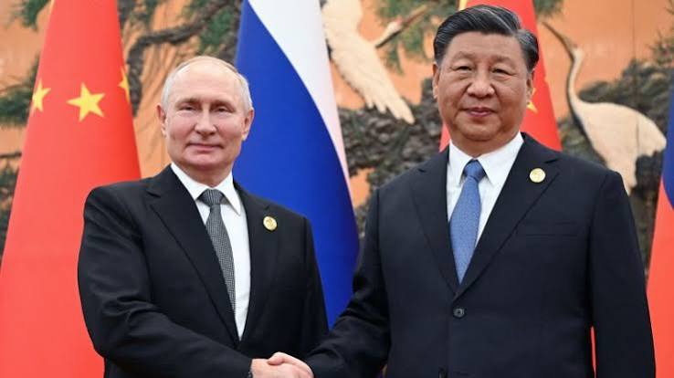 Russian President Vladimir Putin shakes hands with Chinese President Xi Jinping during a meeting in Beijing.
