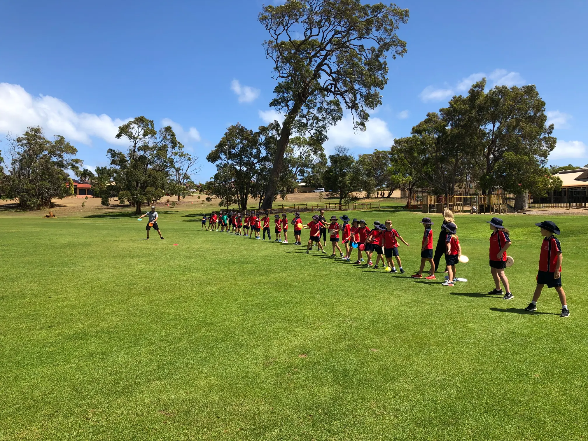 Young people playing disc golf at a camp
