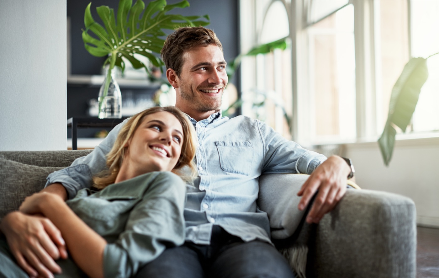 A couple relaxing together in their finished Forté home