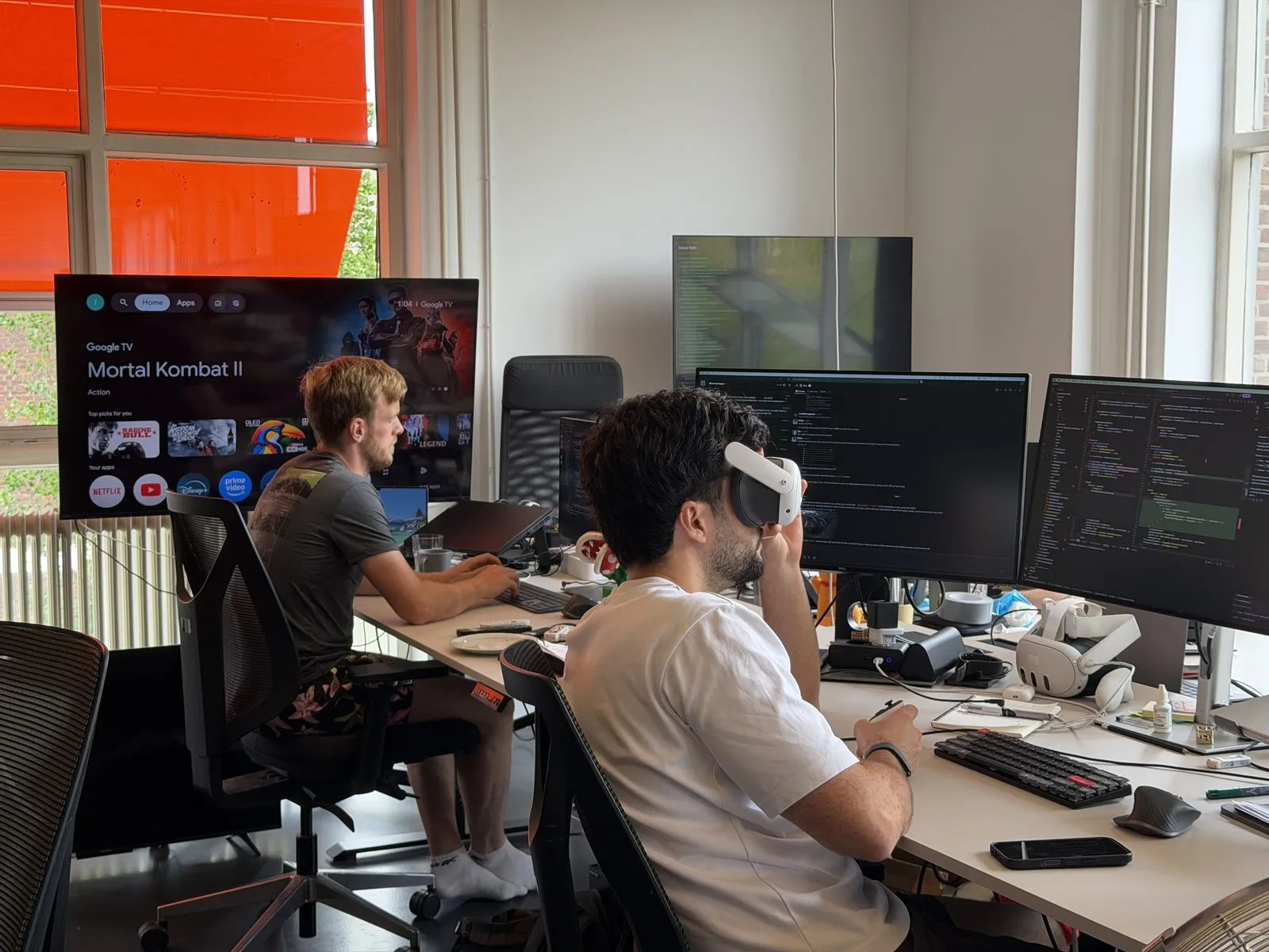 Two Tiledmedia colleagues testing VR playback at their desks
