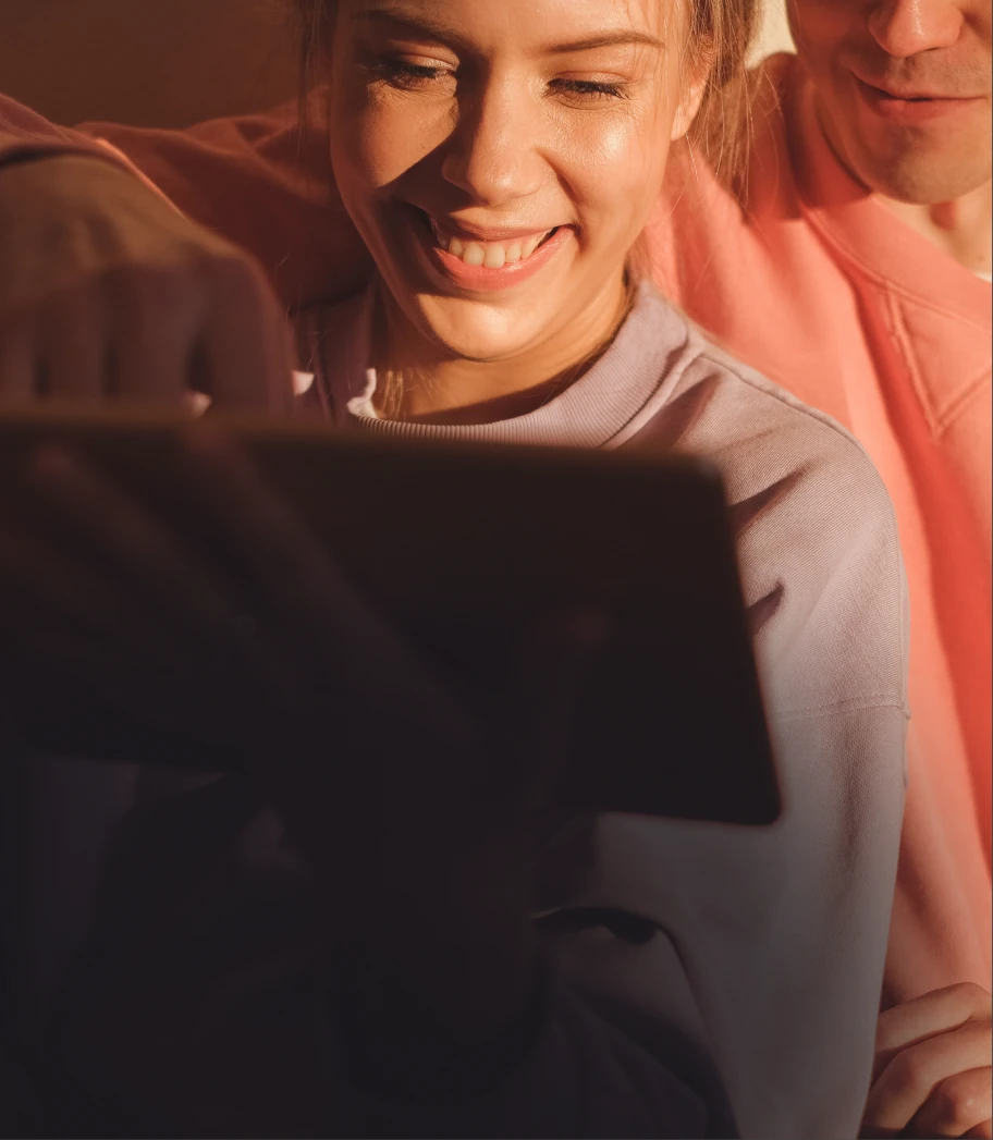 Woman smiling holding an iPad