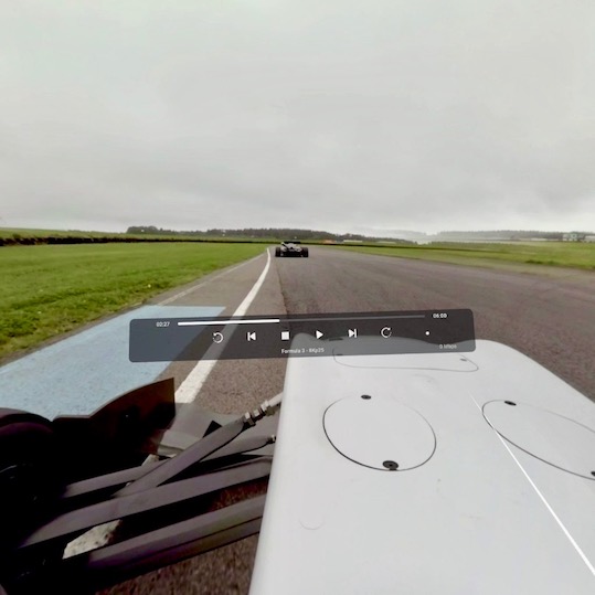 VR view from a race car on a circuit, with player controls overlaid