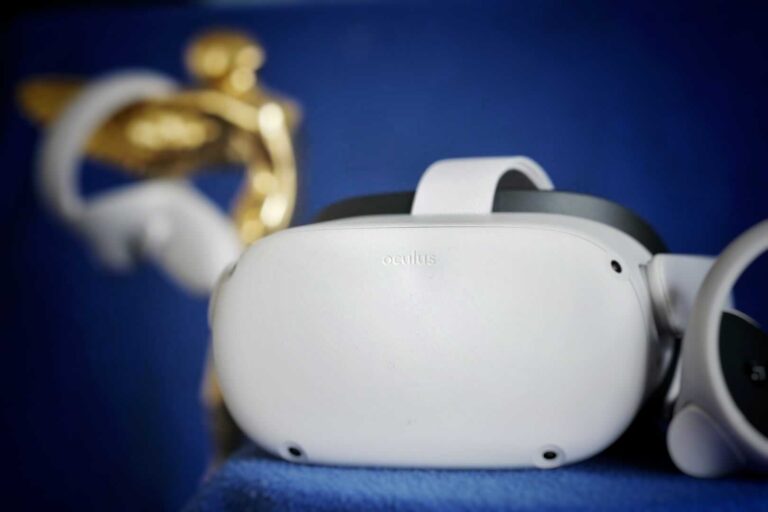 Meta Quest 2 headset with a gold decorative object beside it