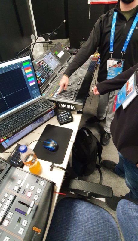 Audio engineers at a mixing desk in the Beijing control room