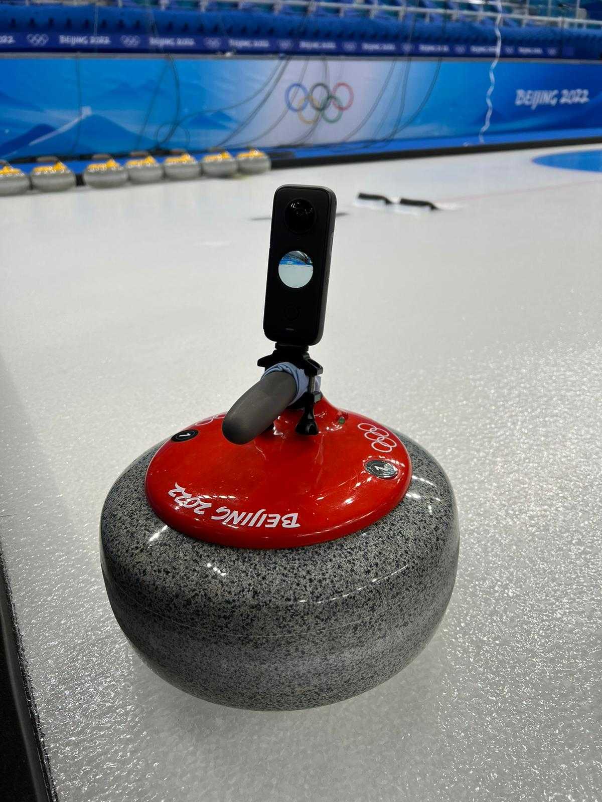 Curling stone with a camera mounted on it on the Beijing 2022 ice