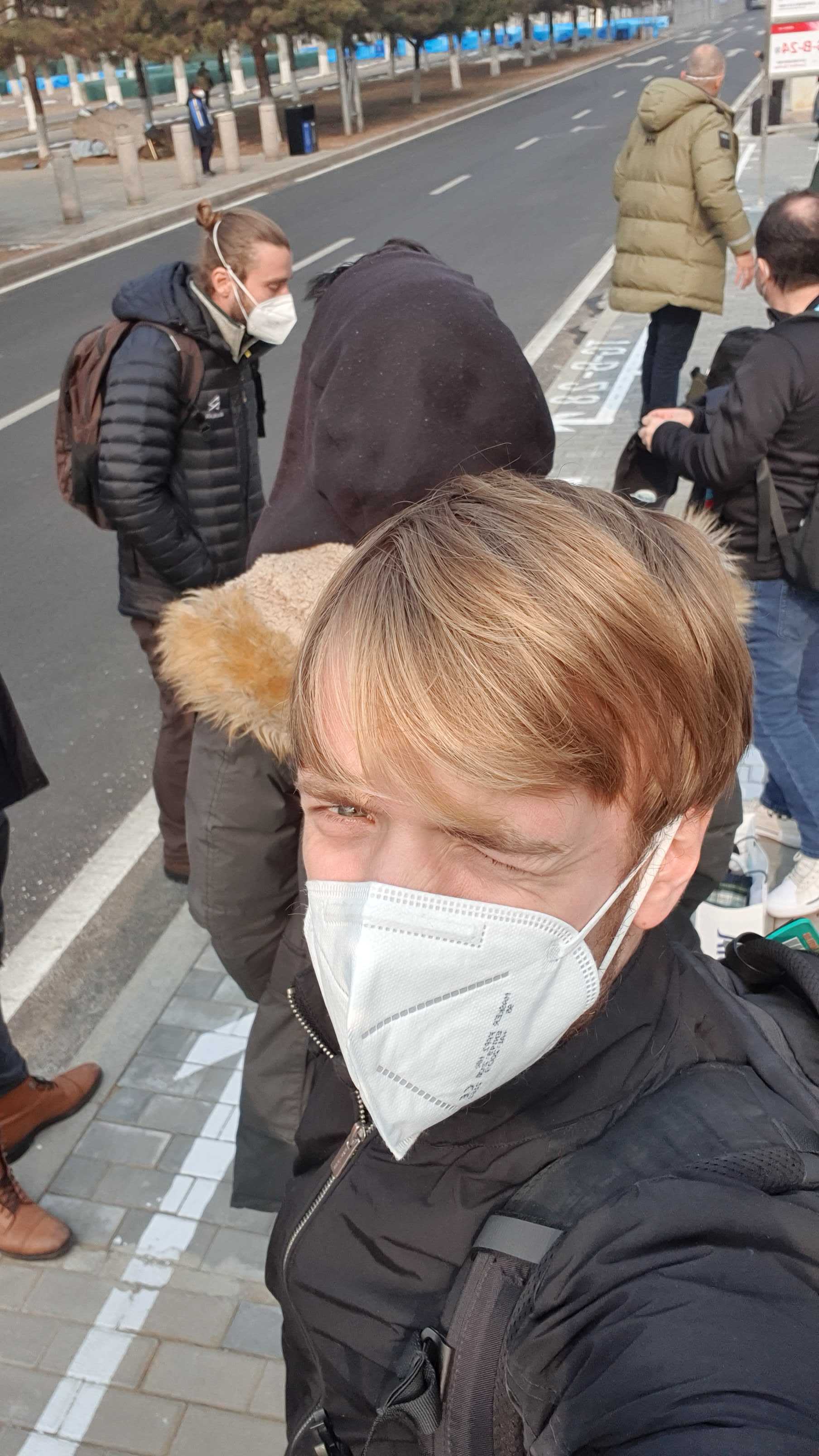 Crew members in face masks outdoors during the Beijing Games