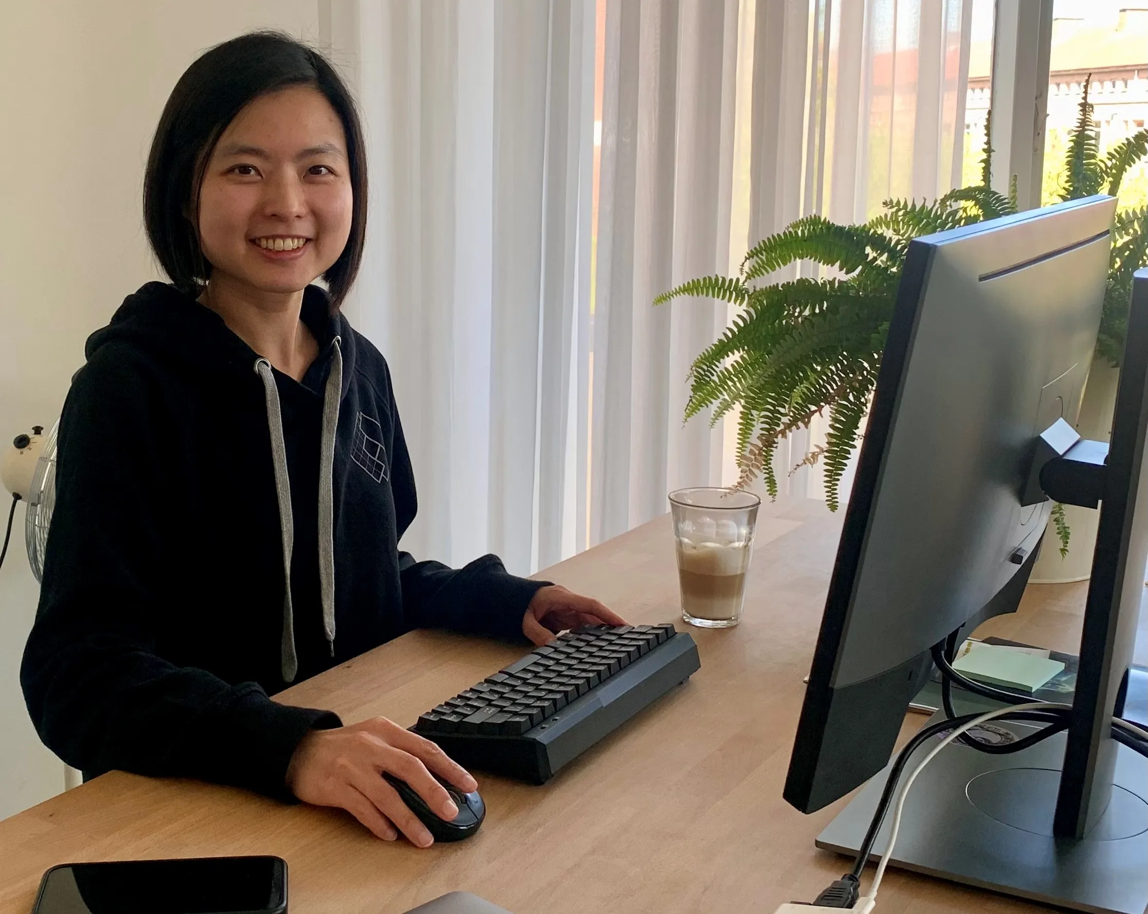 Colleague working at a desk by a window