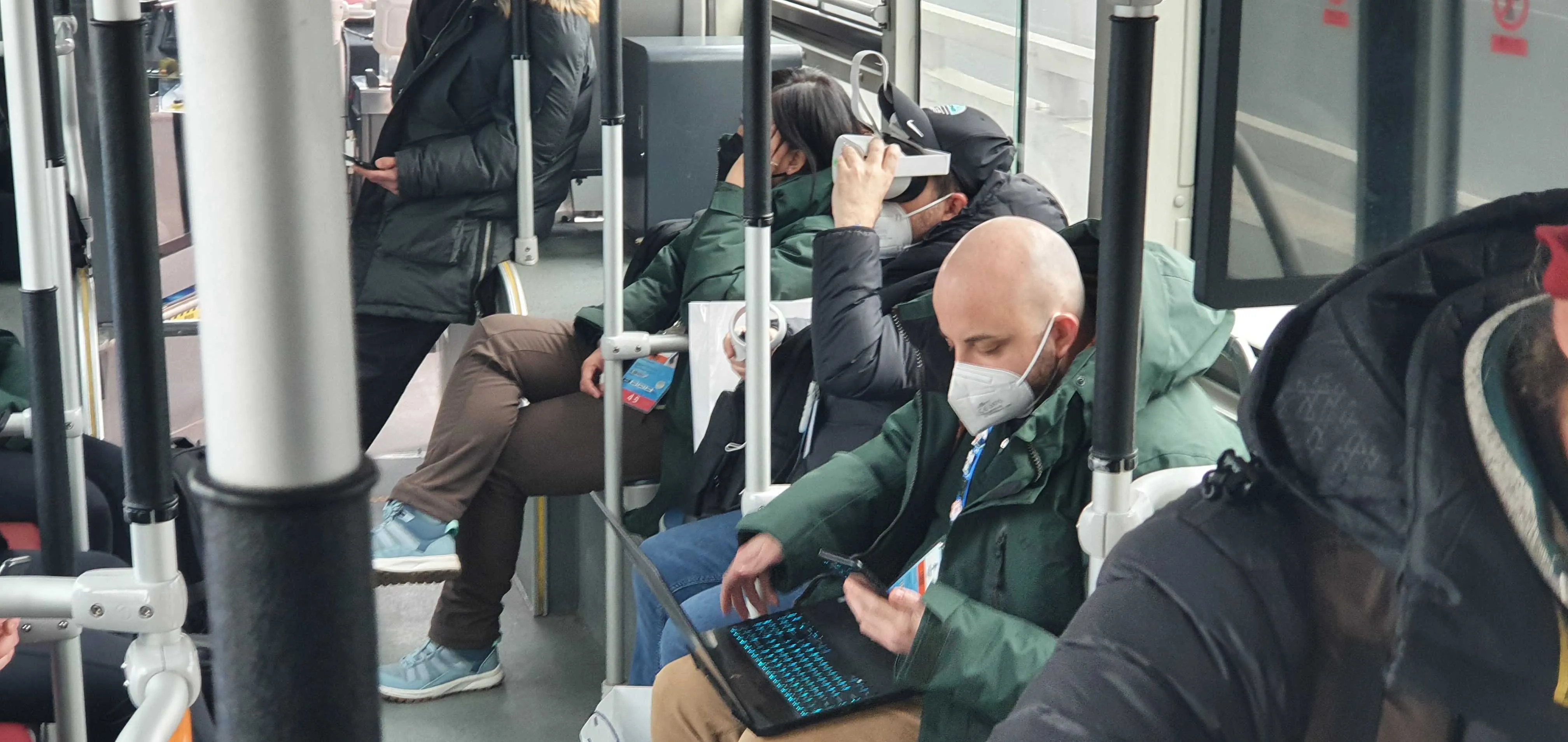 Team working on laptops on the shuttle bus during the daily end-to-end test