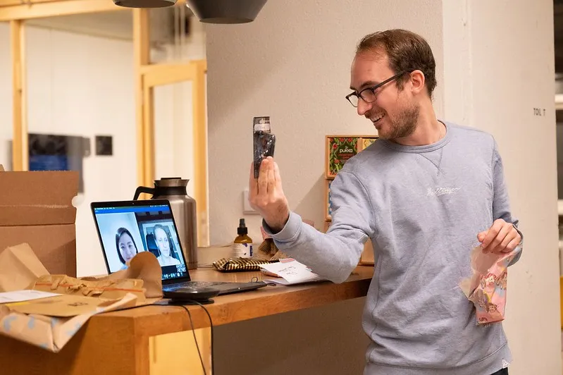 Colleague opening a Sinterklaas present at his desk