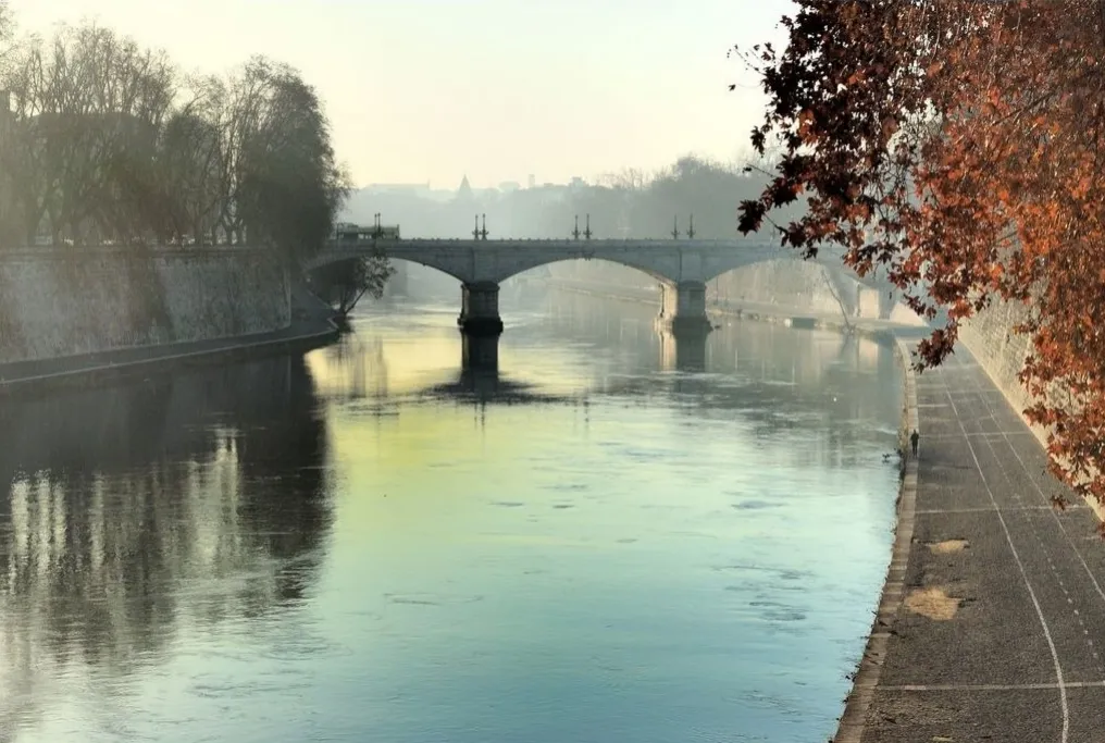 River with a bridge and autumn trees along the bank