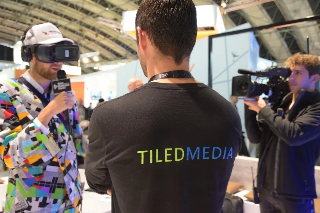 Visitor in a VR headset being filmed at the Tiledmedia stand