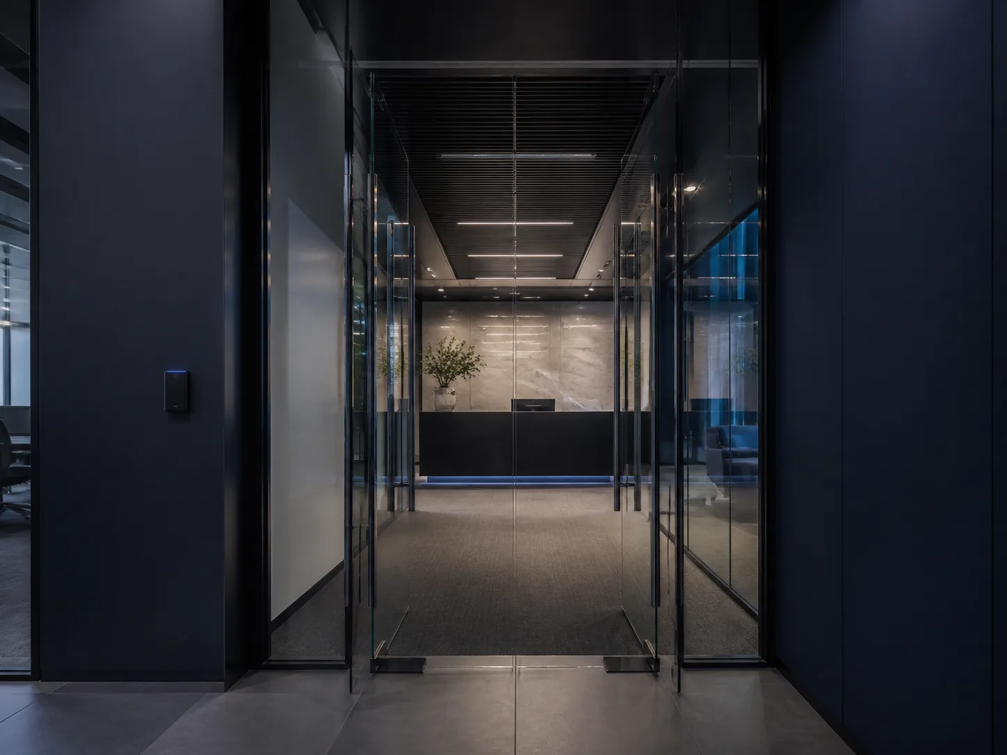 Conceptual modern office entry with glass doors, credential reader, and visible reception area