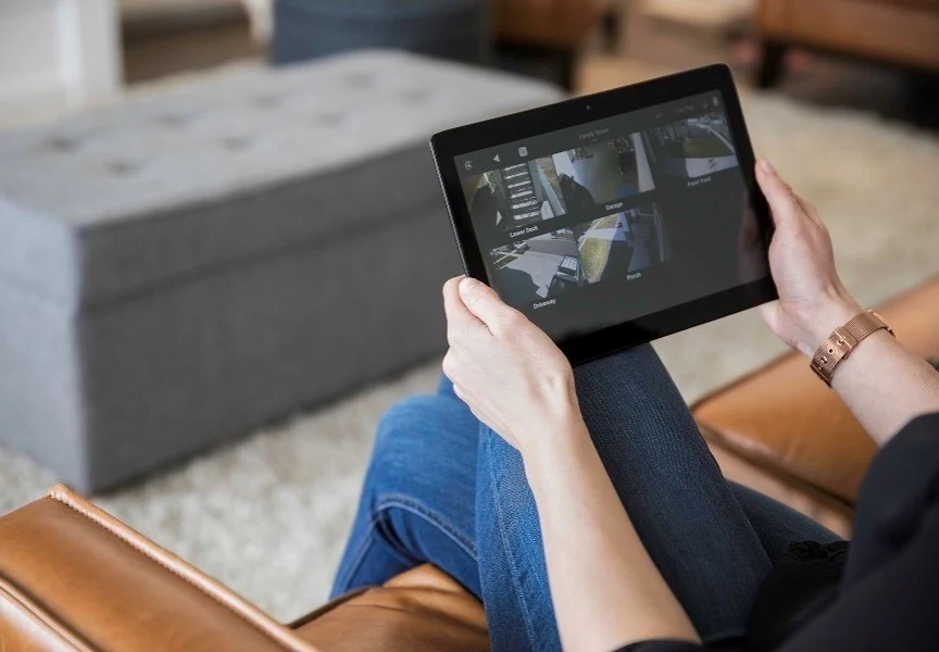 Homeowner using a tablet to control connected home systems