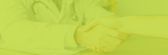 Doctor and patient shaking hands over a care plan