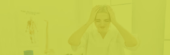 Woman in a lab coat showing signs of stress