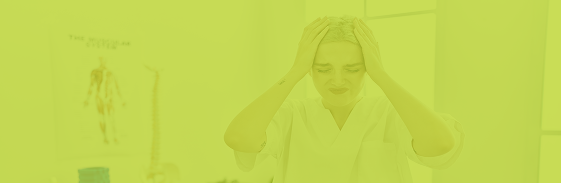Woman in a lab coat showing signs of stress